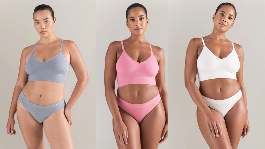 Three women wearing seamless bralettes and high leg briefs in Storm Grey, Rose Pink, and White by Nudea